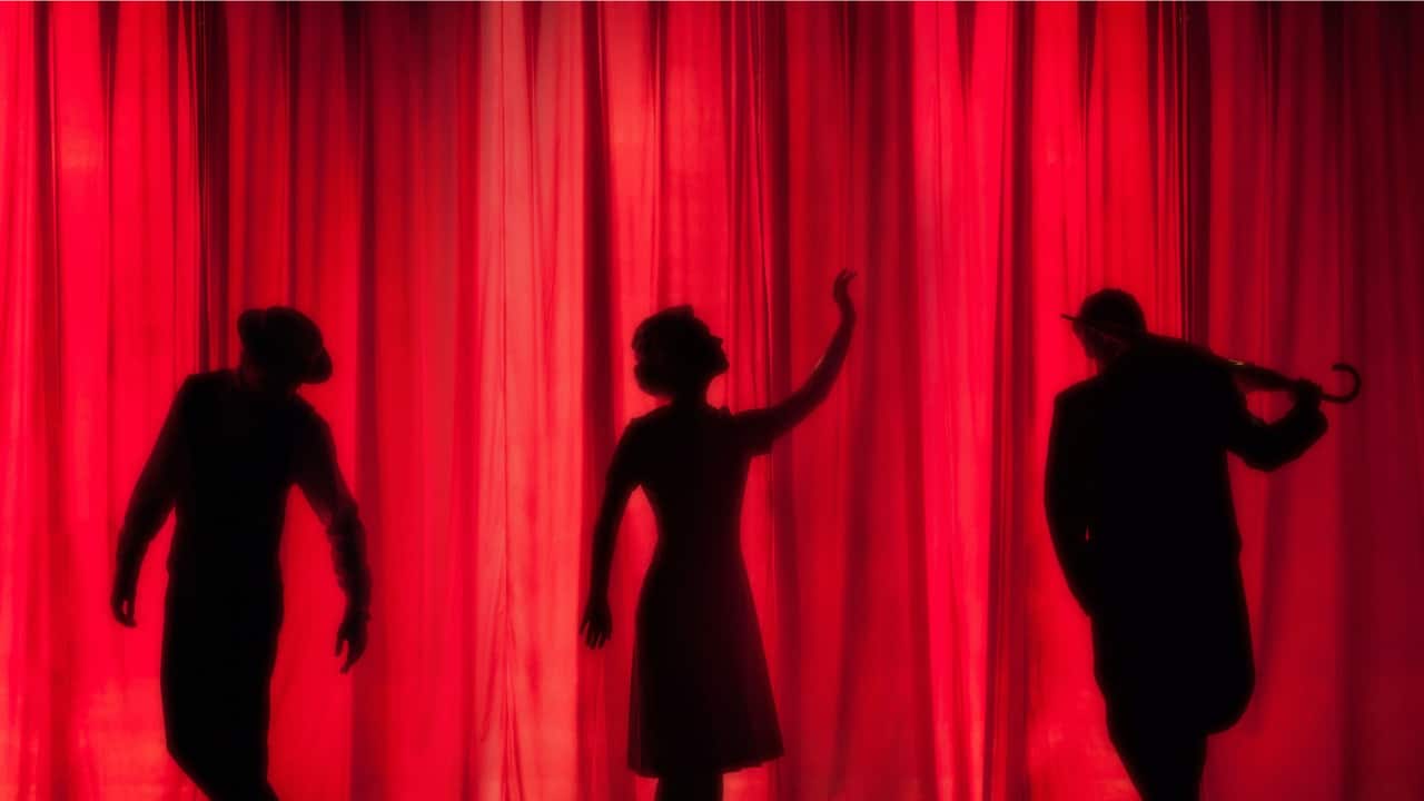 Human Shadows on Red Background. Theatre Scene.